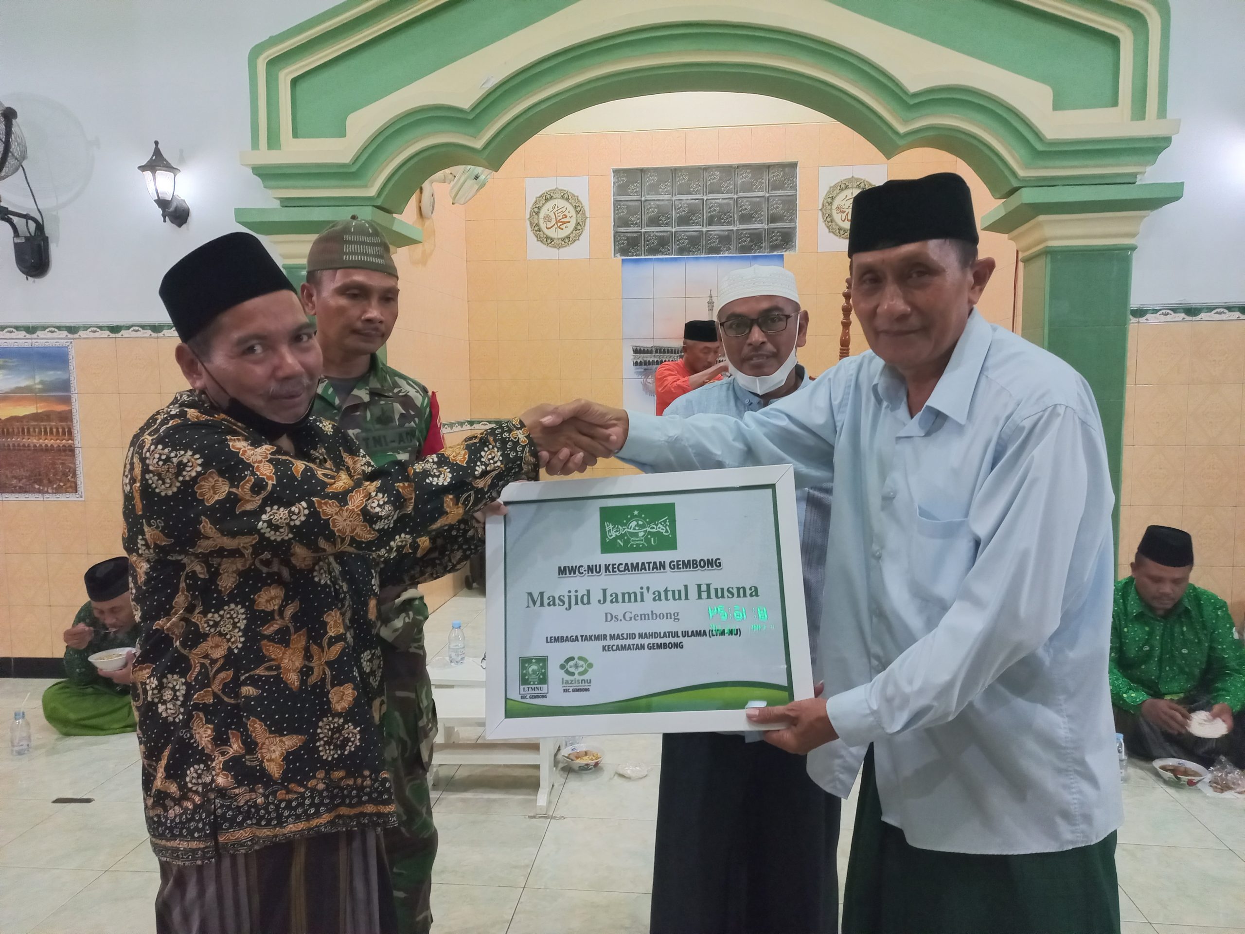 PCNU PATI. Ketua MWC NU Gembong, K. Sholikhin menyerahkan kenang-kenangan kepada ketua takmir Masjid Jami'atul Husna, Dukuh Godangmulyo, Gembong