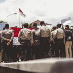 people in green uniform standing on field during daytime