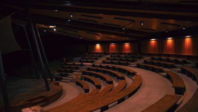 a large auditorium filled with lots of wooden seats