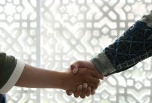 a close up of two people shaking hands