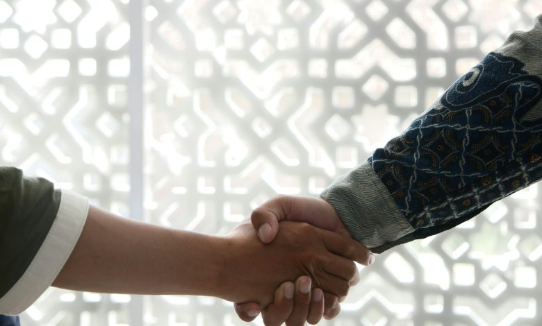 a close up of two people shaking hands