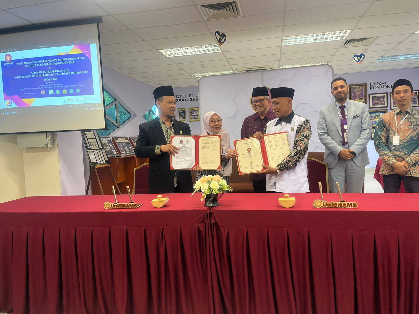 Teken MoU, INISNU dan UniSHAMS Malaysia Langsung Gelar Seminar Konfoerensi Internasional Pcnupati.or.id Temanggung — Institut Islam Nahdlatul Ulama (INISNU) Temanggung resmi menandatangani nota kesepahaman (MoU) dengan Universiti Islam Antarabangsa Sultan Abdul Halim Mu’adzam Shah (UniSHAMS) Malaysia, sebagai bagian dari penguatan kerja sama internasional di bidang pendidikan, penelitian, dan pengabdian masyarakat. Penandatanganan ini dilaksanakan bertepatan dengan kegiatan Seminar Konferensi Internasional bertajuk “Multiculturalism and Religious Moderation: The Perspective of Islamic Studies in Indonesia and Malaysia”, yang digelar pada Kamis, 28 Agustus 2025 di UniSHAMS, Malaysia. Sedangkan tema yang dibawakan UniSHAMS adalah "Pengajian Islam di Nusantara: Cabaran dan Harapan" yang menjadi tindaklanjut konkret pelaksanaan MoU tersebut. MoU ini merupakan salah satu agenda penting dalam rangkaian program Pancadharma Internasional INISNU Temanggung yang diselenggarakan di tiga negara: Singapura, Malaysia, dan Thailand. Rektor INISNU Temanggung, Dr. Muh. Baehaqi, M.M., menyampaikan bahwa penandatanganan MoU ini menjadi langkah konkret dalam memperluas jaringan kerja sama global, khususnya dalam pengembangan studi Islam yang moderat dan berbasis pada nilai-nilai multikulturalisme. Konferensi yang mengiringi momen MoU ini menghadirkan Prof. Madya Dr. Mukhamad Hadi Musolin Subagio, Dekan Kulliyyah Usuluddin, Sains Al-Qur’an & Bahasa Arab UniSHAMS Malaysia, serta Dr. Eny Rahmawati, M.Pd., Dosen Magister Pendidikan Agama Islam INISNU Temanggung, sebagai pembicara utama. Selain itu, sejumlah dosen dan mahasiswa Magister INISNU Temanggung juga turut menjadi presenter, antara lain Dr. Fatmawati Sungkawaningrum, M.S.I. (Dosen Magister Hukum Keluarga Islam INISNU Temanggung), Khailani Khumairoh, Laila Salma, Muhamad Wahid Afiudin dan Agus Akhmat Yani (Mahasiswa Magister Pendidikan Agama Islam INISNU Temanggung). Ketua Panitia Pancadharma Internasional, Dr. Hamidulloh Ibda menegaskan bahwa kerja sama ini bukan hanya simbolik, melainkan akan ditindaklanjuti dengan program nyata seperti pertukaran pelajar, joint research, dan publikasi ilmiah bersama. “Melalui MoU ini, kami ingin membangun kolaborasi berkelanjutan dengan UniSHAMS, sebagai mitra strategis dalam membentuk generasi cendekiawan Muslim yang moderat dan mampu bersaing di level global,” ujarnya. Dekan Kulliyyah of Usuluddin, Quranic Sciences and Arabic Language (KUBRA), Universiti Islam Antarabangsa Sultan Abdul Halim Mu'adzam Shah (UniSHAMS) Malaysia Prof Madya Hadi Musolin Subagio mengatakan bahwa Universiti Islam Antarabangsa Sultan Abdul Halim Mu'adzam Shah (UniSHAMS) Malaysia adalah kampus hak milik pemerintah Provinsi Kedah, Malaysia. "Sejarahnya, pada tahun 1994 mengadaman kerjasama dengan Universitas Al Azhar. Salah satu programnya dulu adalah belajar 3 tahun di Malaysia dan 1 tahun di Mesir," jelasnya. Profesor asal Bojonegoro, Jawa Timur, Indonesia itu menambahkan bahwa pengembangan UniSHAMS 80 persen meminjam dari Al-Azhar, dan sampai saat ini ada 30 persen dosen masih native bahasa Arab Mesir. Selain penandatanganan MoU, seminar konferensi internasional, kegiatan di sana juga dilakukan visiting class antara dosen dan mahasiswa. "Silakan nanti masuk kelas untuk bertukar ilmu dan pengalaman," lanjutnya. Pihaknya juga menambahkan bahwa di UniSHAMS ada lima fakultas dari diploma sampai doktoral. Naib Canselor Pembangunan, Penyelidikan dan Inovasi UniSHAMS Malaysia Prof. Dr. Ahmad Rozelan Bin Yunus menyambut baik kedatangan enam perguruan tinggi dari Indonesia tersebut, yaitu INISNU Temanggung, IAI An Nawawi Purworejo, STAINU Purworejo, STAI Al Anwar Sarang, STAI Al Kamal Sarang, dan Ma'had Aly KH. Maemun Zubair Sarang. "Di sini, rata-rata yang datang adalah kampus yang fokus pada pengkajian Islam, nanti ke depan bisa bekerja sama dari urusan akademik, penyelidikan karena hampir semua yang datang di sini serumpun dengan pengkajian Islam," katanya. Prof Rozelan juga mengatakan bahwa singkatan KUBRA adalah Kulliyyah of Usuluddin, Quranic Sciences and Arabic Language. "Karena namanya panjang disingkat KUBRA," tegas dia. Penandatanganan MoU itu dilakukan di sela-sela Seminar Konferensi Internasional berpusat di Perpustakaan UniSHAMS. Kegiatan ini mendapat dukungan penuh dari berbagai lembaga di lingkungan Nahdlatul Ulama serta sejumlah perguruan tinggi mitra, sebagai wujud sinergi dalam membangun peradaban Islam yang rahmatan lil ‘alamin.