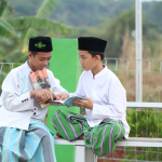 A couple of men sitting on top of a bench