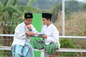 A couple of men sitting on top of a bench
