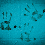three hand prints on white wall